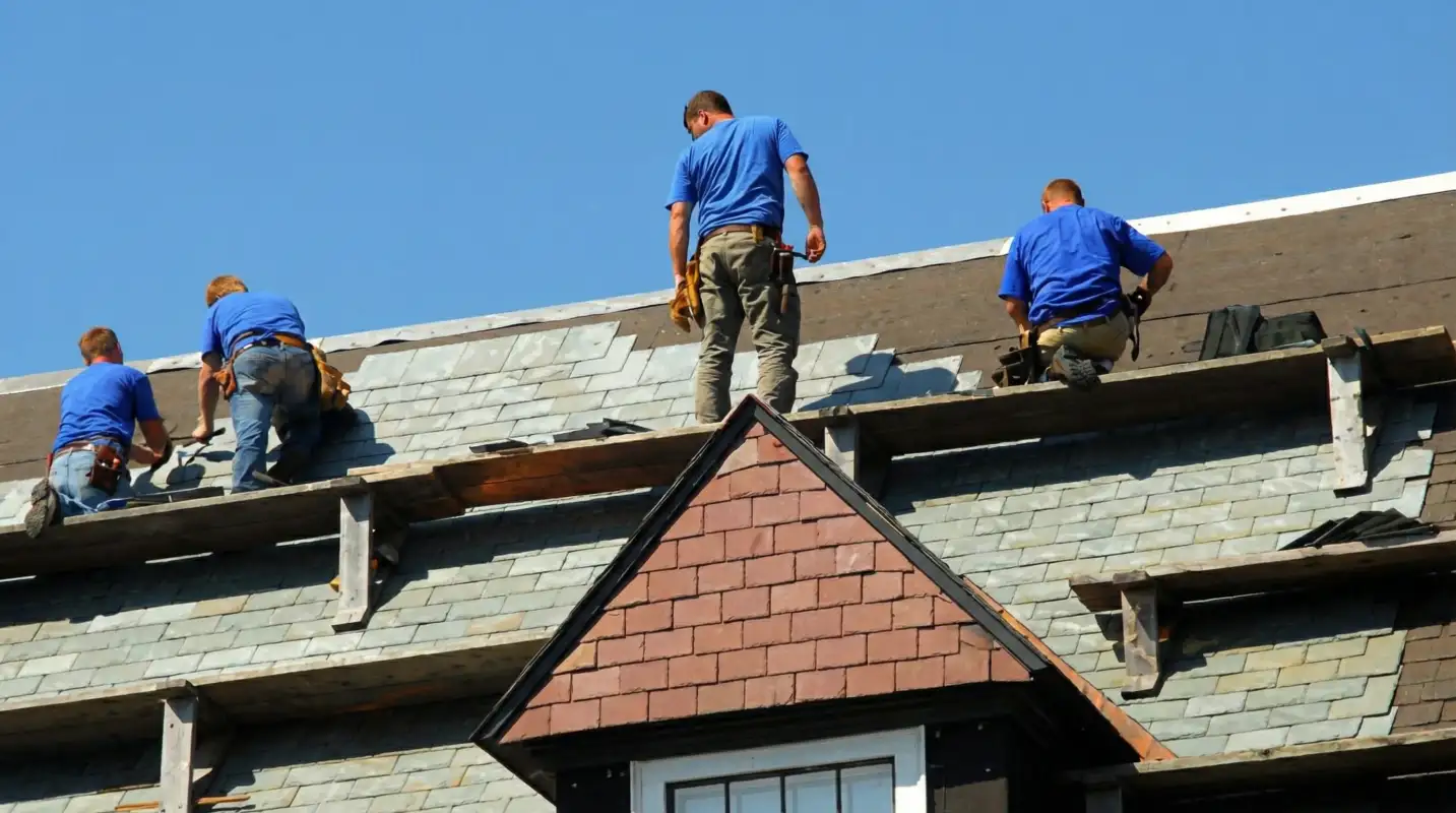 Roof replacement in progress with a team of professional contractors installing new shingles on a residential home in Sarasota, FL