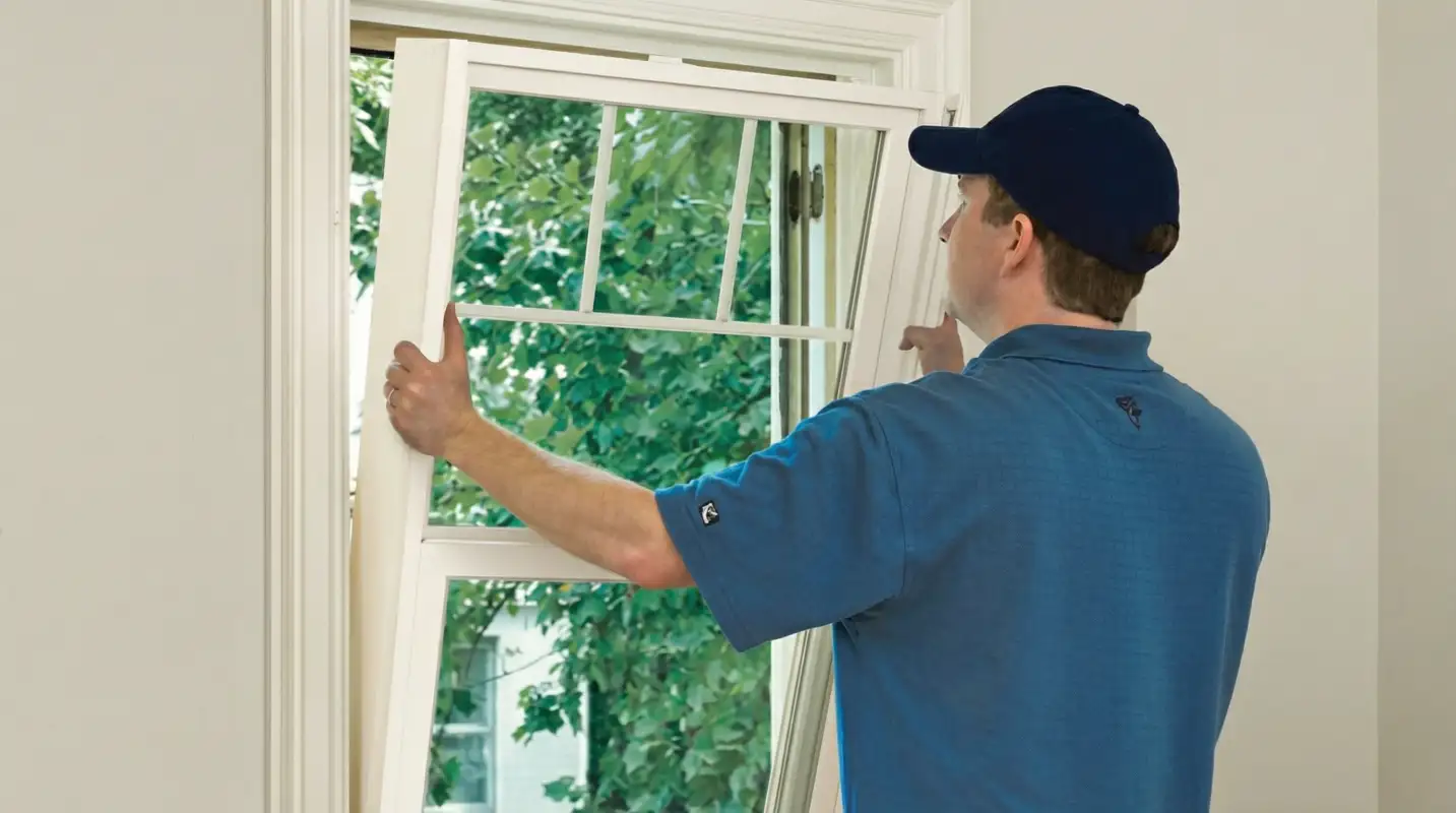 Professional contractors performing a residential window insulation and replacement service in Sarasota, FL